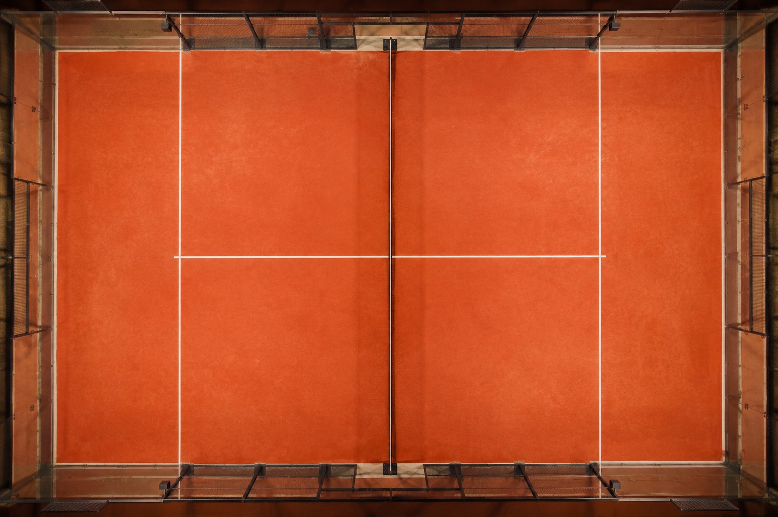 Indoor terracotta padel court seen from above